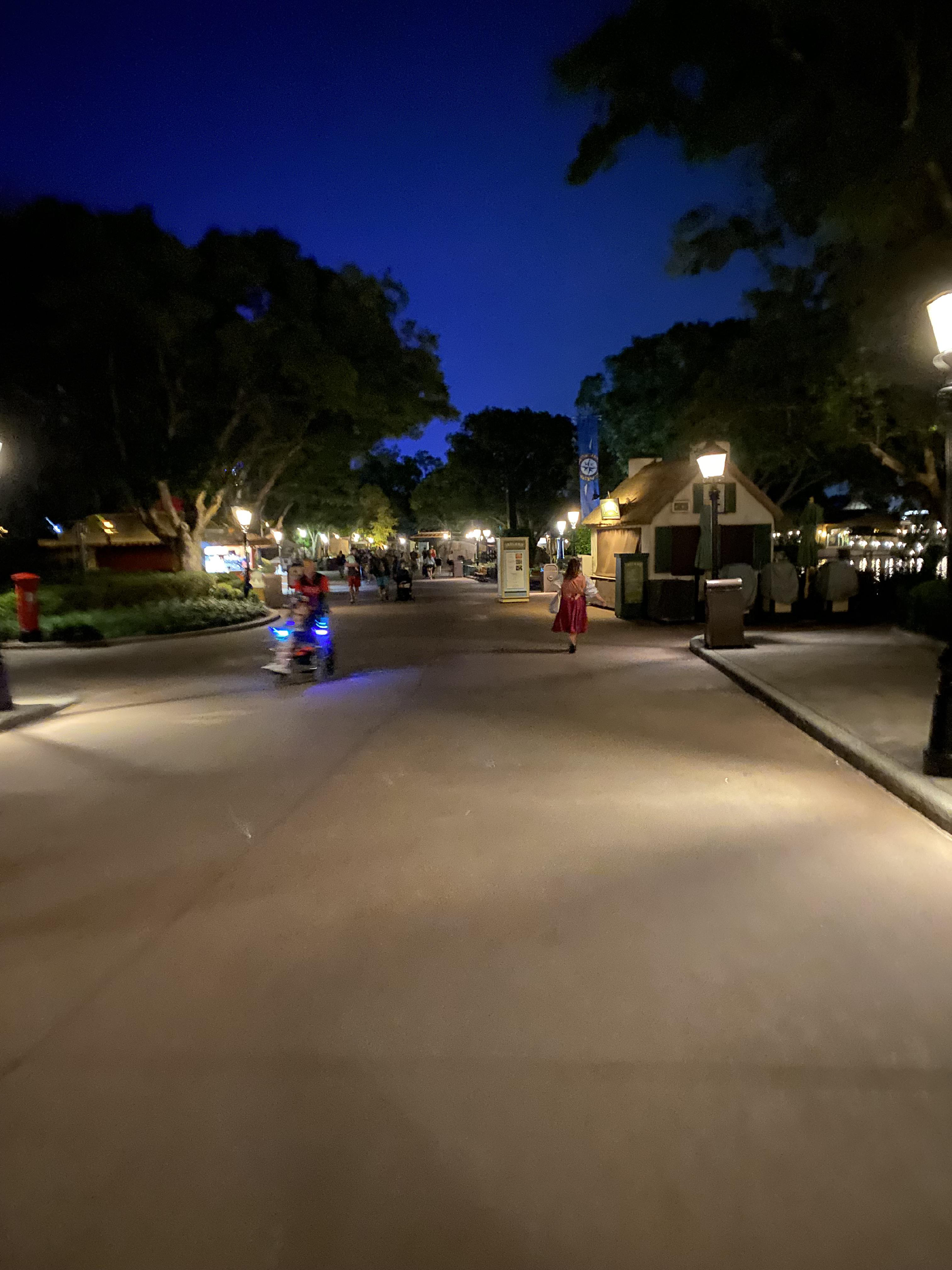 Nightime view of World Showcase. It&rsquo;s an empty walkway with very few people around