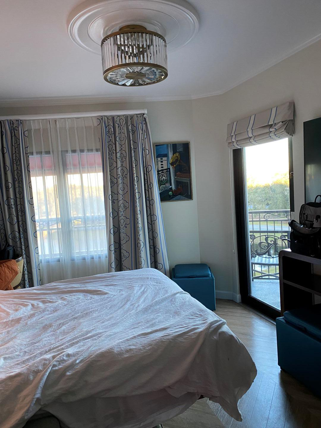 Hotel room with a pullout bed, a dresser, TV, and a door to a patio