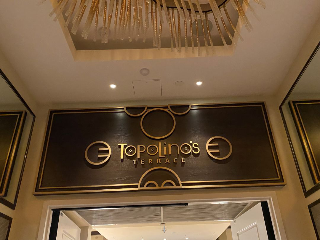 Sign and chandelier at entrance to restaurant