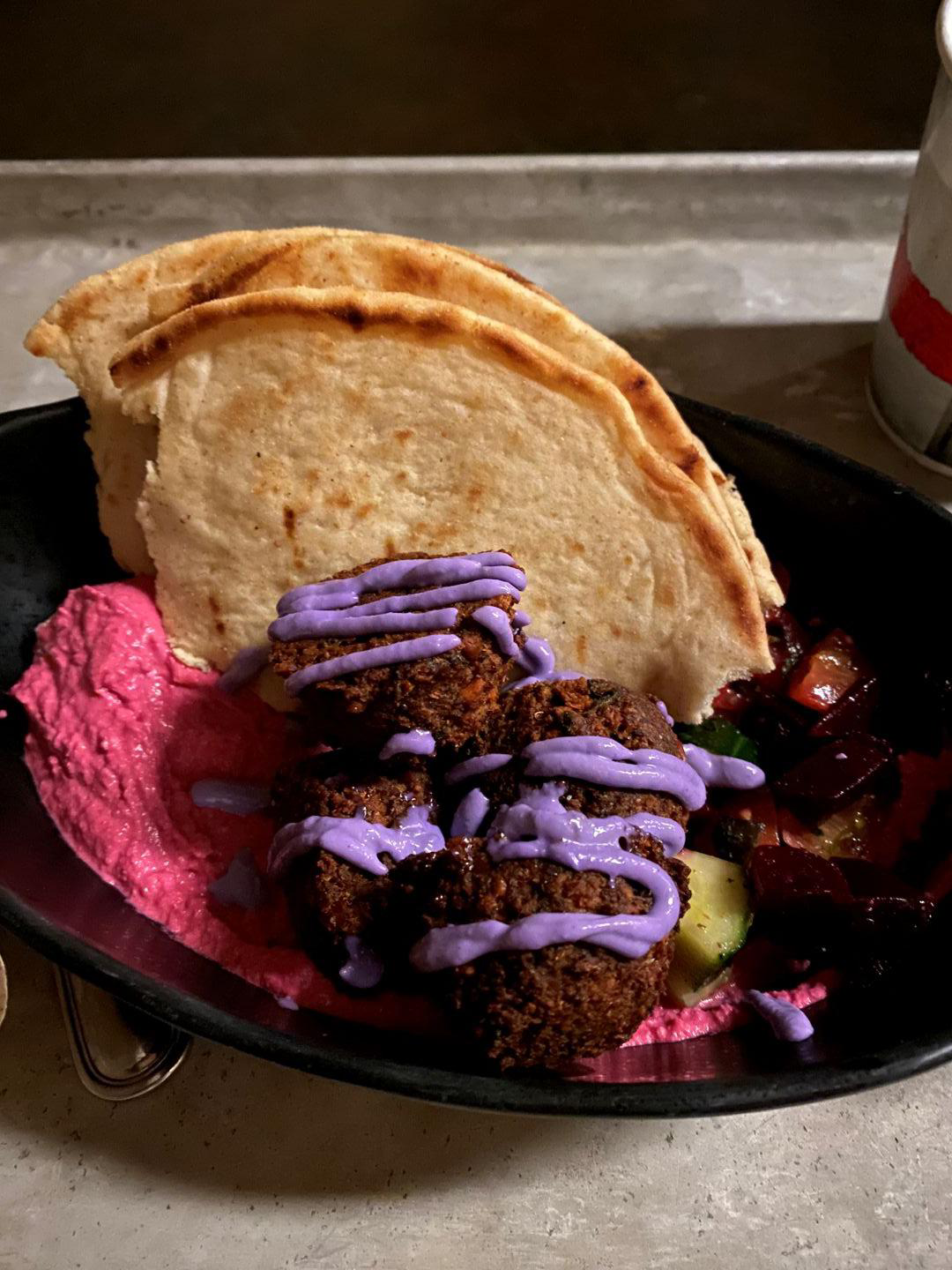 Meal in a bowl of falafel, pita, hummus and veggies